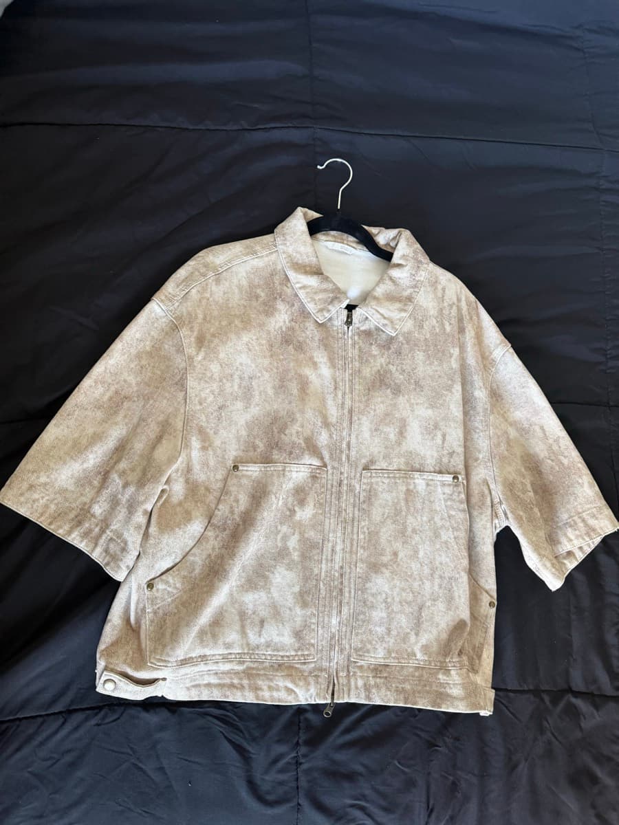 A tan canvas chore jacket